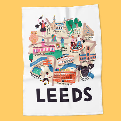 Tea towel with a colorful illustration of Leeds landmarks on a yellow background